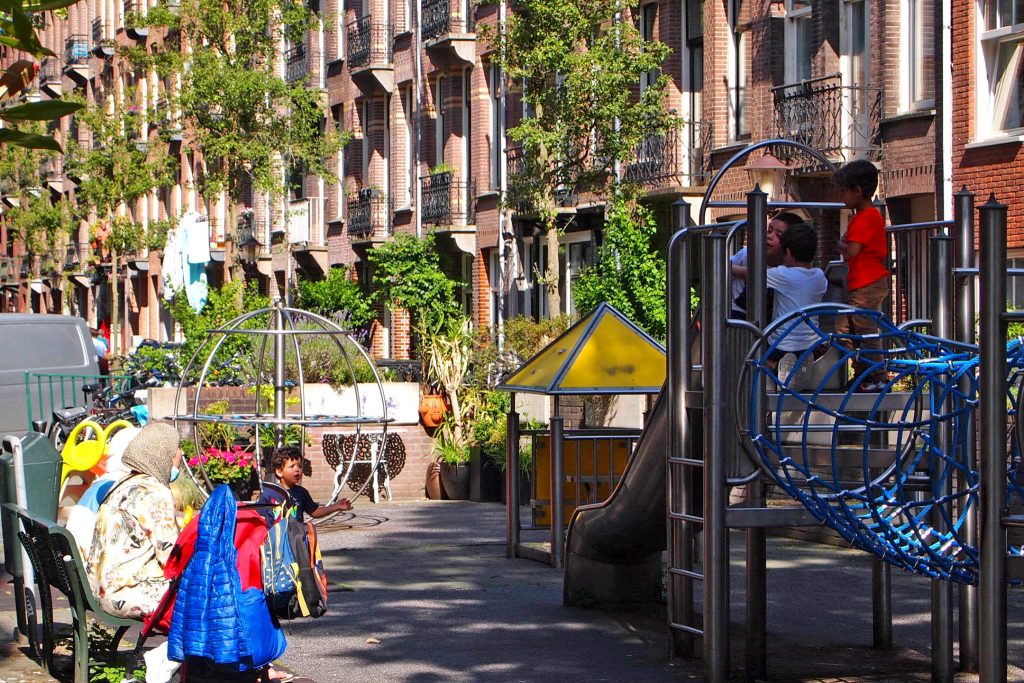 Crianças brincam em playground na rua de Vrolikstraat.